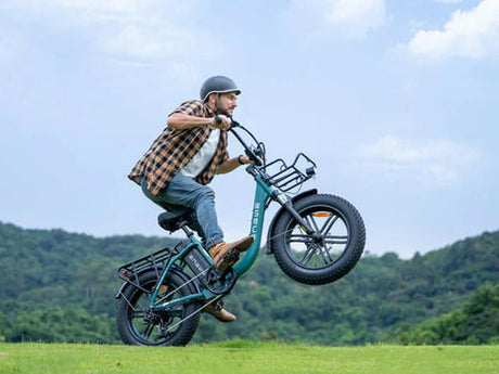 a man rides an engwe l20 boost e-bike on the grass