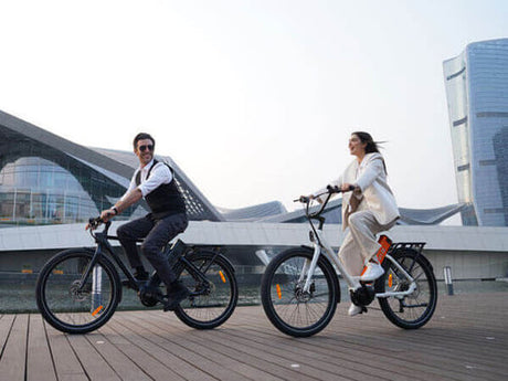 a gentleman and a lady respectively riding 2 engwe p275 e-bikes