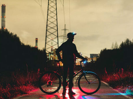 a man stands next to an e-bike