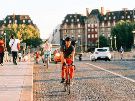 people riding bicycles in traffic