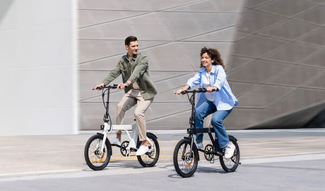 a man and a woman riding engwe p20 urban ebikes on the road