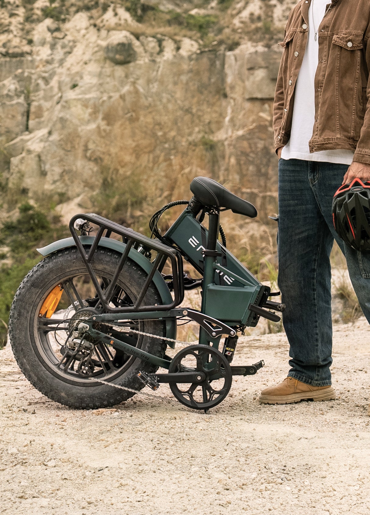 a man standing next to a folded engwe engine pro 2.0 compact ebike