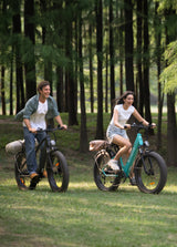 two people riding 2 engwe e26 all terrain e bikes on the grass